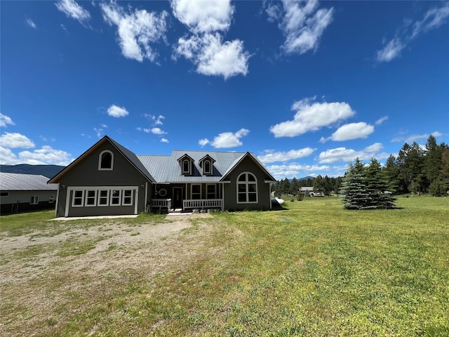 back of property featuring covered porch and a yard