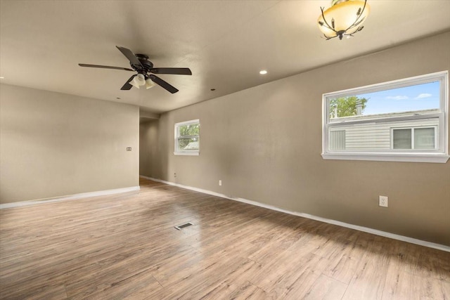 unfurnished room with hardwood / wood-style floors and ceiling fan