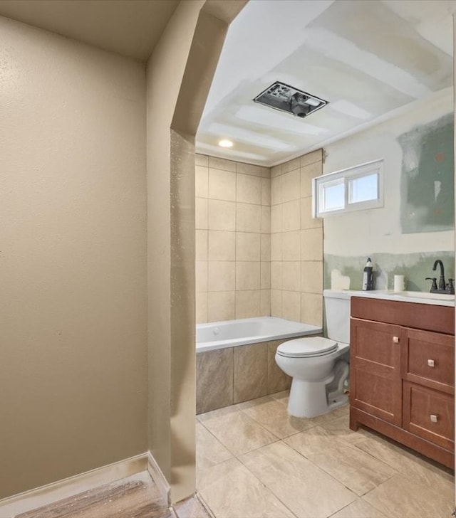 full bathroom featuring tile patterned floors, vanity, tiled shower / bath combo, and toilet