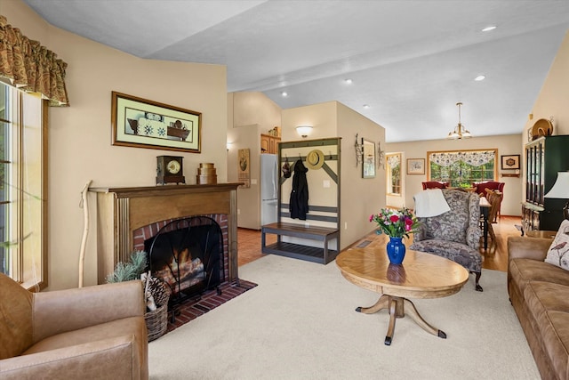 carpeted living room with lofted ceiling and a brick fireplace