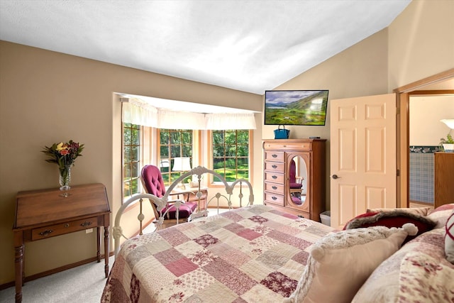 bedroom with carpet flooring and lofted ceiling