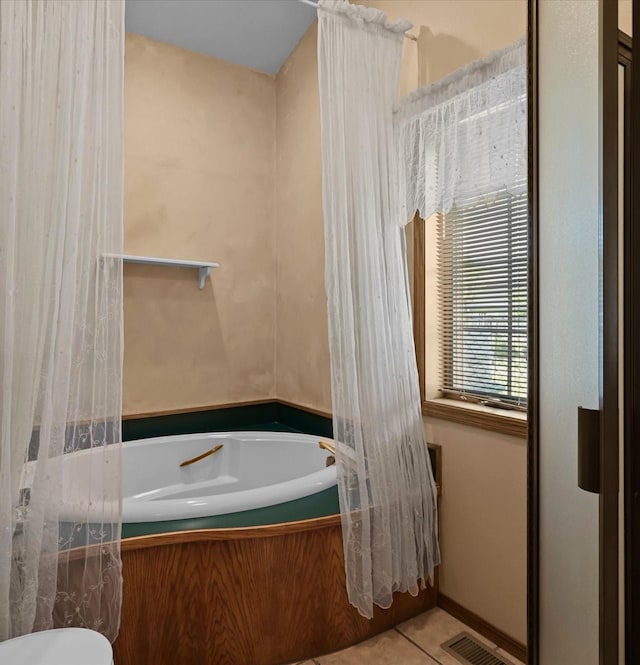 bathroom featuring tile patterned floors and a bathing tub