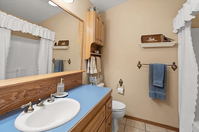 bathroom with tile patterned floors, a shower with curtain, vanity, and toilet