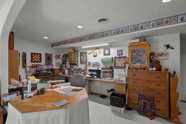 office space with light colored carpet and built in desk