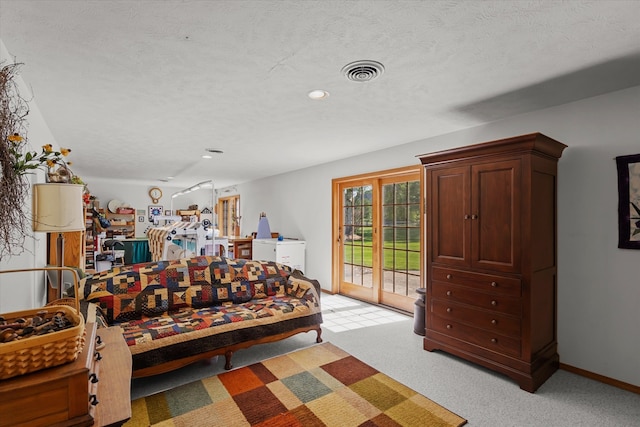 carpeted bedroom featuring access to exterior and a textured ceiling