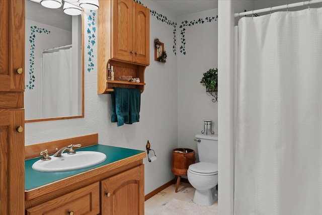 bathroom featuring tile patterned flooring, vanity, toilet, and walk in shower