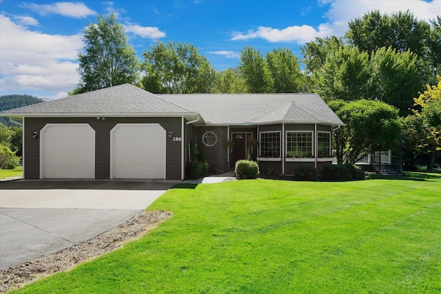 single story home featuring a front lawn and a garage