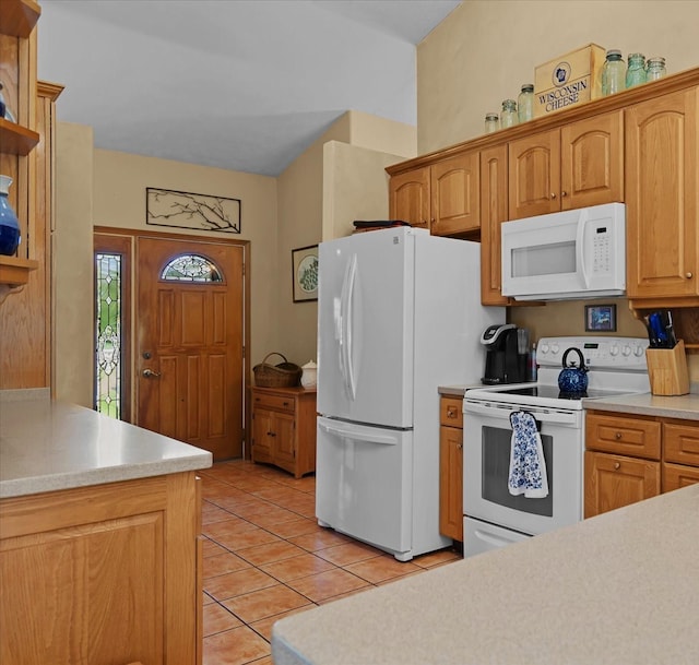 kitchen featuring white appliances and light tile patterned flooring