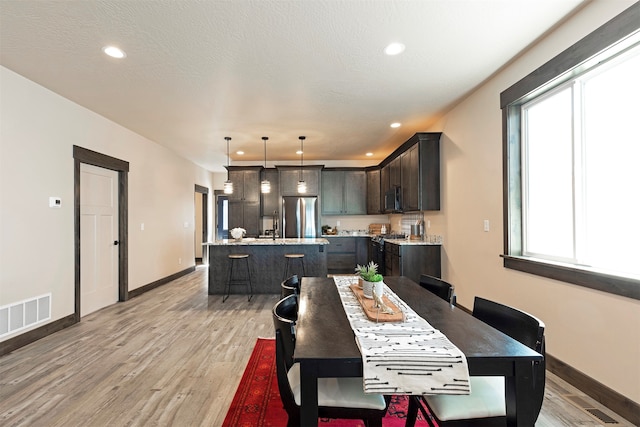 dining area with light hardwood / wood-style floors