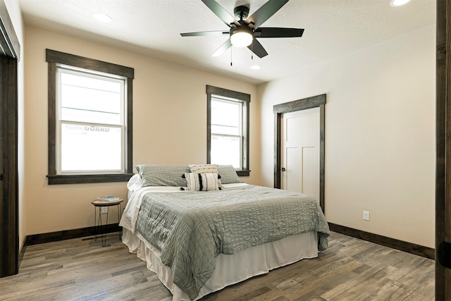 bedroom with wood-type flooring and ceiling fan