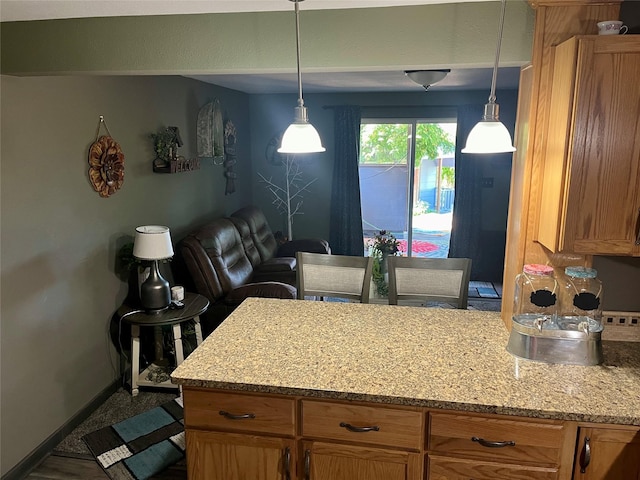 kitchen with pendant lighting and light stone counters