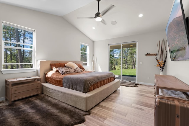 bedroom featuring ceiling fan, vaulted ceiling, multiple windows, and access to outside