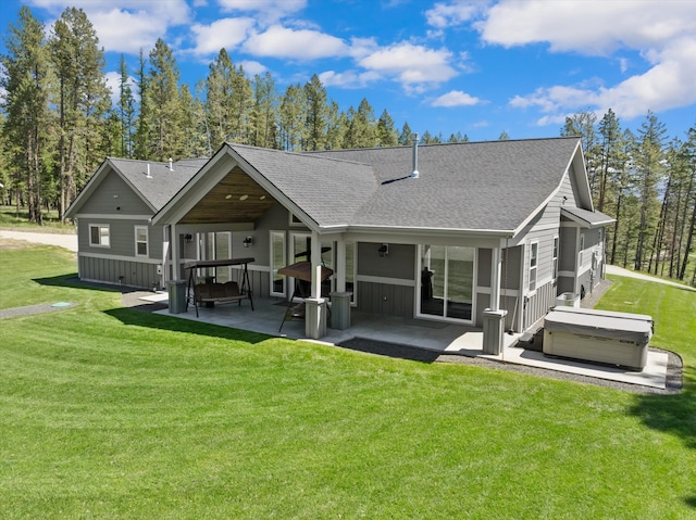 rear view of house featuring a patio area and a lawn