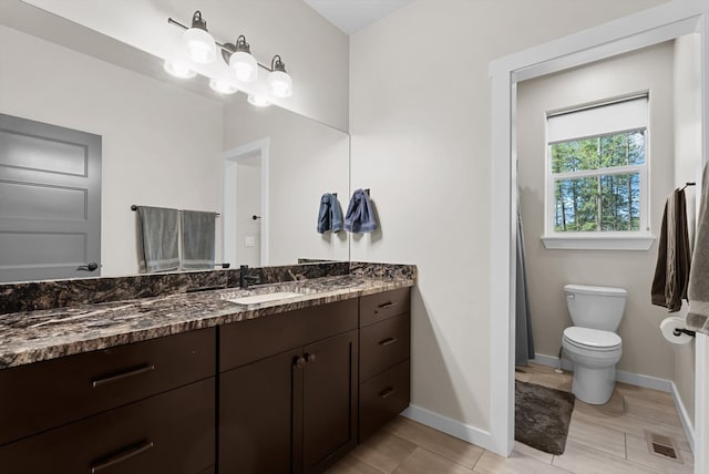 bathroom featuring vanity and toilet