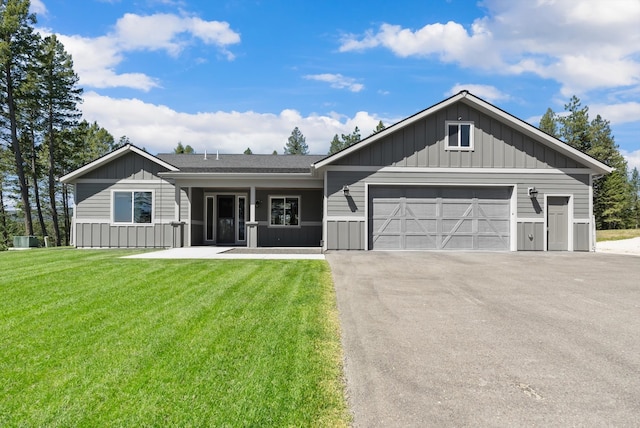 view of front of property with a garage and a front yard