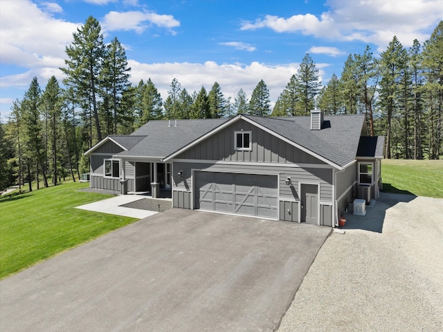 view of front of house featuring a front yard and a garage