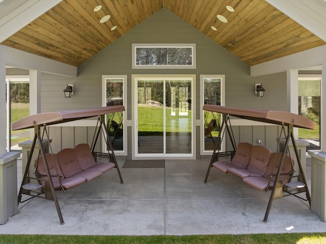 sunroom / solarium featuring lofted ceiling and wood ceiling