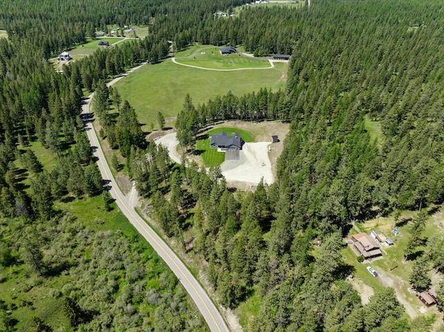 drone / aerial view featuring a forest view