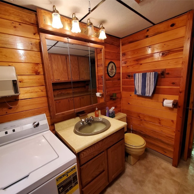 15426 Steamboat Dr, Augusta, MT 59410 - bathroom with vanity, wood walls, toilet, and washer / dryer