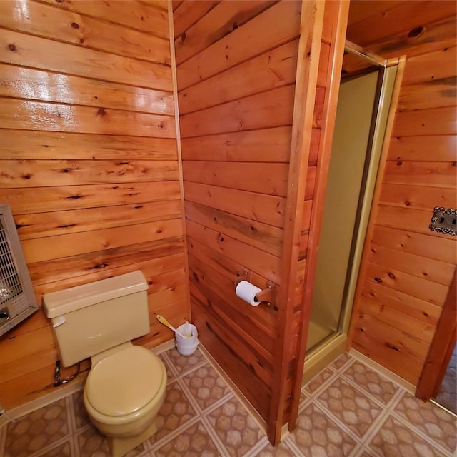 15426 Steamboat Dr, Augusta, MT 59410 - bathroom with toilet, a stall shower, wood walls, and tile patterned floors
