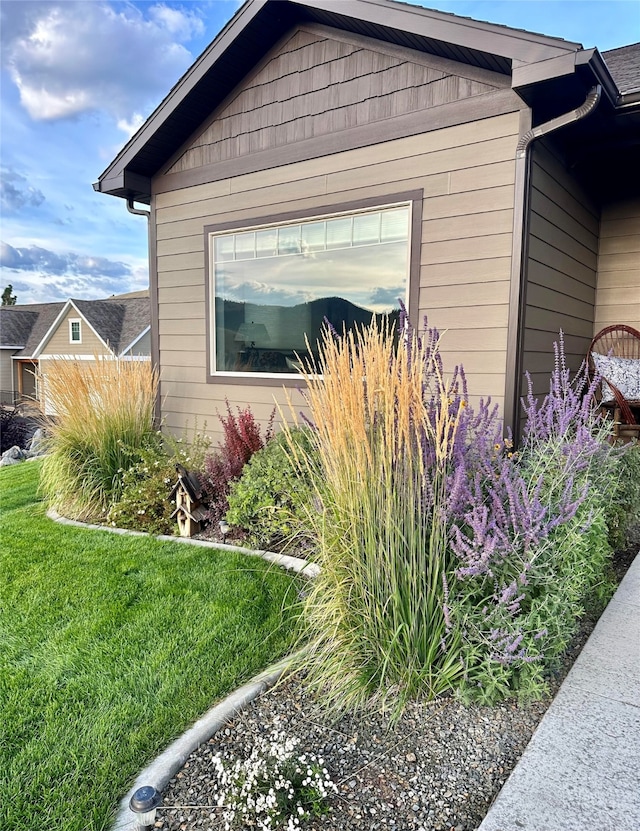 view of side of home featuring a lawn