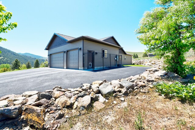 view of home's exterior featuring a garage and a mountain view