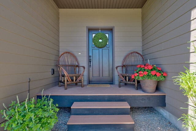 view of exterior entry with a porch