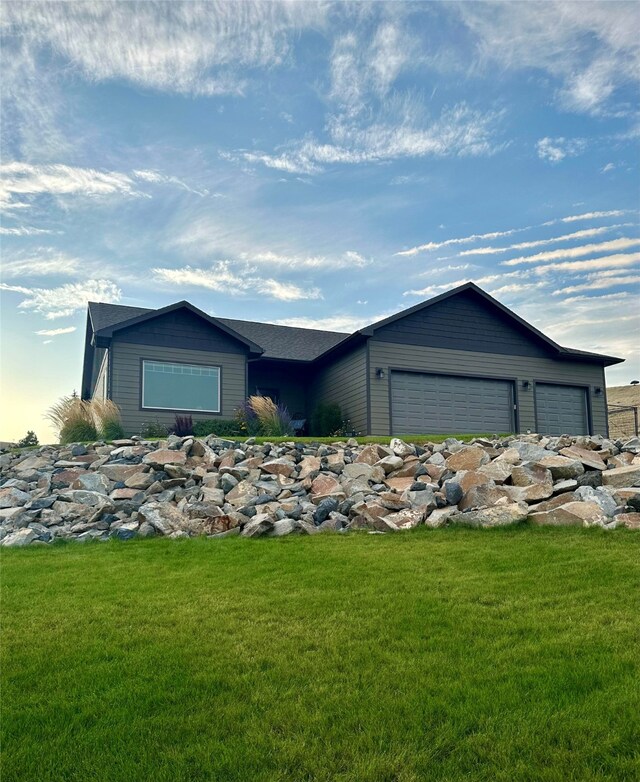 ranch-style home with a garage and a front yard