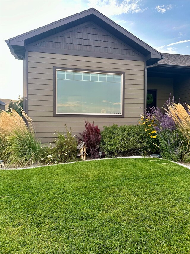 view of property exterior with a lawn