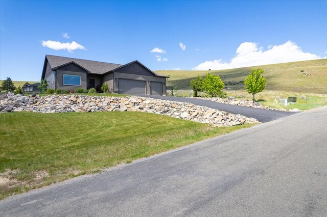 view of front of house with a garage and a front yard