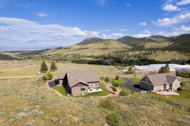 birds eye view of property with a mountain view and a rural view