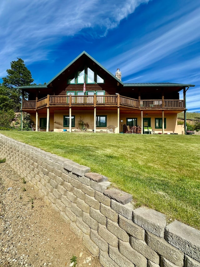 back of house featuring a wooden deck and a yard