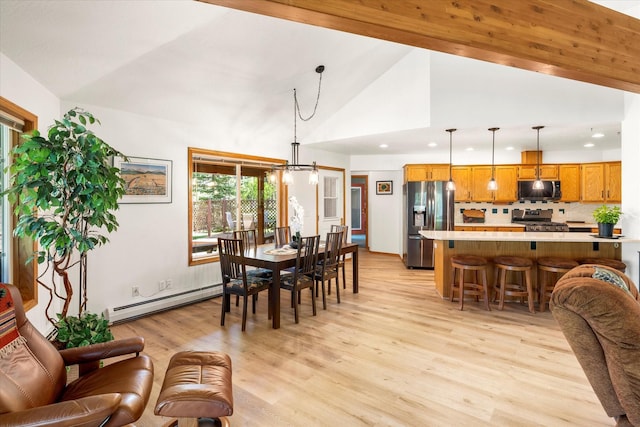 dining space featuring a chandelier, a baseboard radiator, lofted ceiling, and light hardwood / wood-style floors