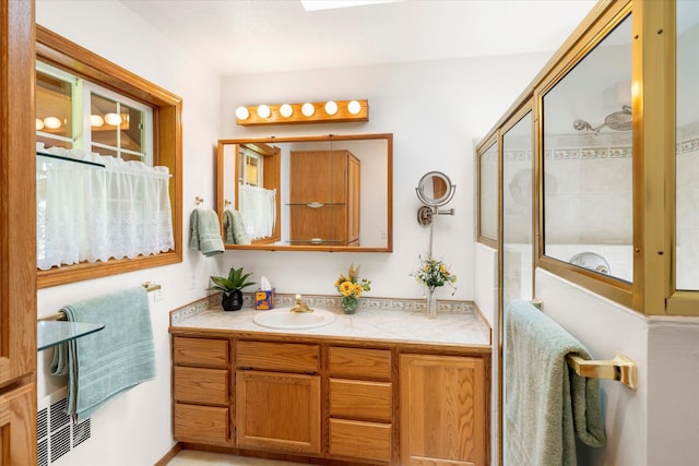 bathroom featuring vanity and a shower