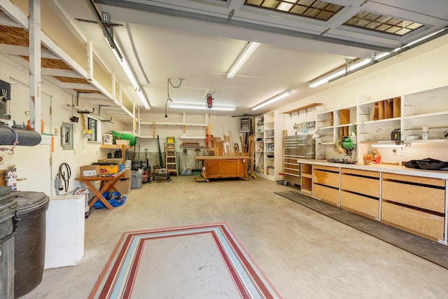 garage with a workshop area and electric panel