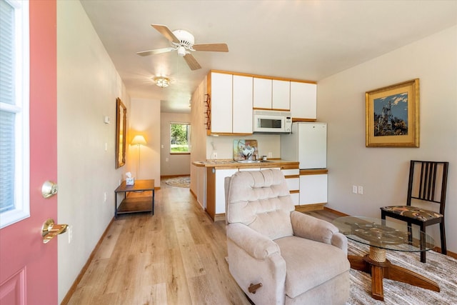 interior space featuring light hardwood / wood-style floors and ceiling fan