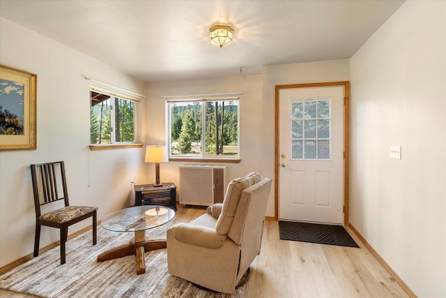 sitting room with light hardwood / wood-style floors and radiator