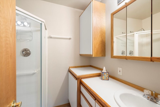 bathroom with a shower with door and sink