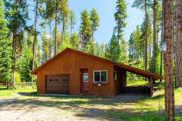 exterior space featuring a garage and an outbuilding