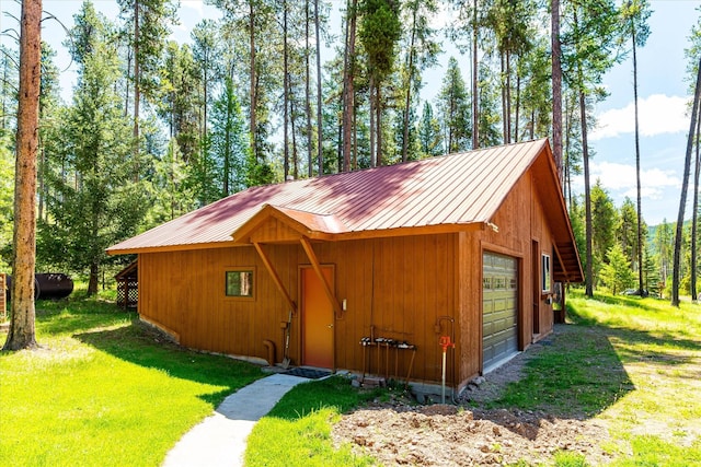 view of outbuilding featuring a lawn and a garage