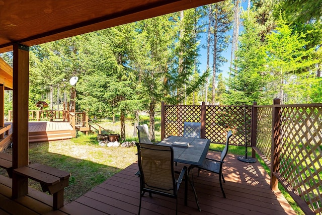 wooden terrace with a lawn