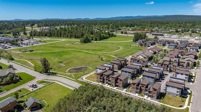 281 Blackberry Loop Unit A, Whitefish, MT 59937 - aerial view of residential area featuring a forest and a mountain backdrop