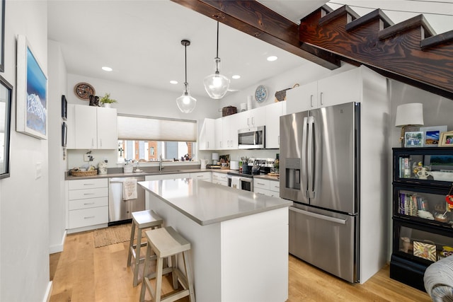 281 Blackberry Loop Unit A, Whitefish, MT 59937 - kitchen featuring stainless steel appliances, a sink, recessed lighting, light wood-type flooring, and white cabinetry