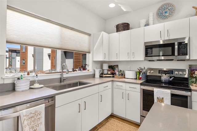 281 Blackberry Loop Unit A, Whitefish, MT 59937 - kitchen with appliances with stainless steel finishes, a sink, light countertops, and white cabinetry