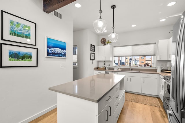 281 Blackberry Loop Unit A, Whitefish, MT 59937 - kitchen with a sink, light wood finished floors, white cabinetry, a kitchen island, and recessed lighting