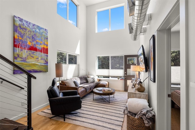 281 Blackberry Loop Unit A, Whitefish, MT 59937 - living room with plenty of natural light, wood finished floors, a high ceiling, and stairs