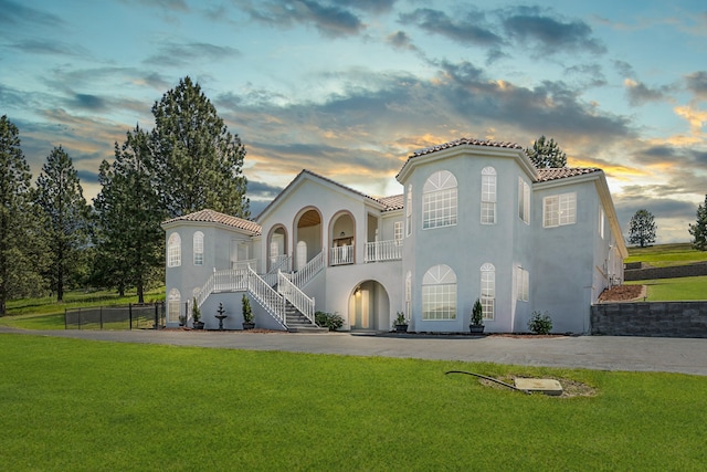 mediterranean / spanish house featuring a lawn