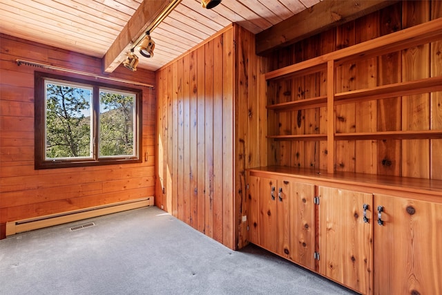 carpeted spare room with lofted ceiling with beams, a baseboard radiator, wood walls, and wood ceiling