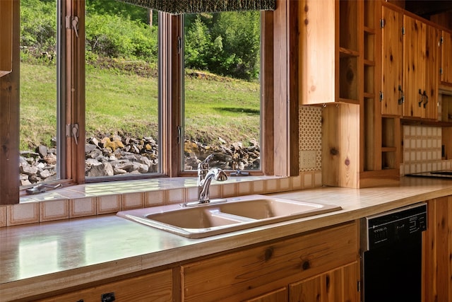 kitchen with dishwasher, sink, a wealth of natural light, and backsplash