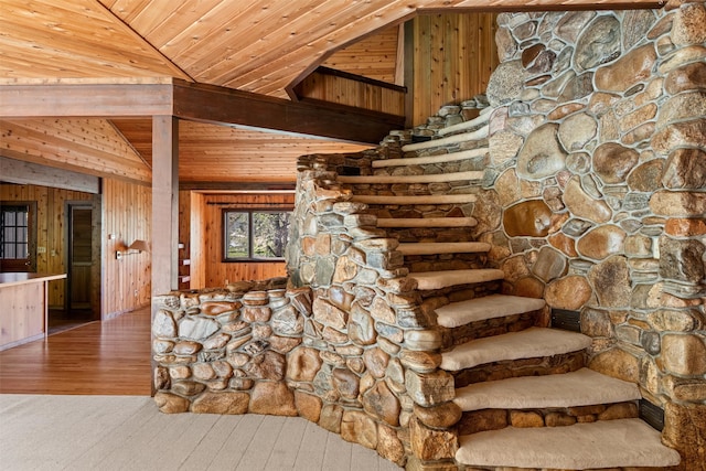 stairway with wood ceiling, wooden walls, and wood-type flooring